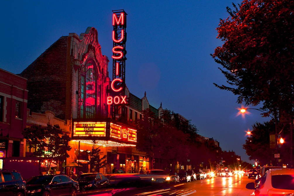 Photograph of Southport Avenue with the exterior of Music Box Theatre lit up in the evening.