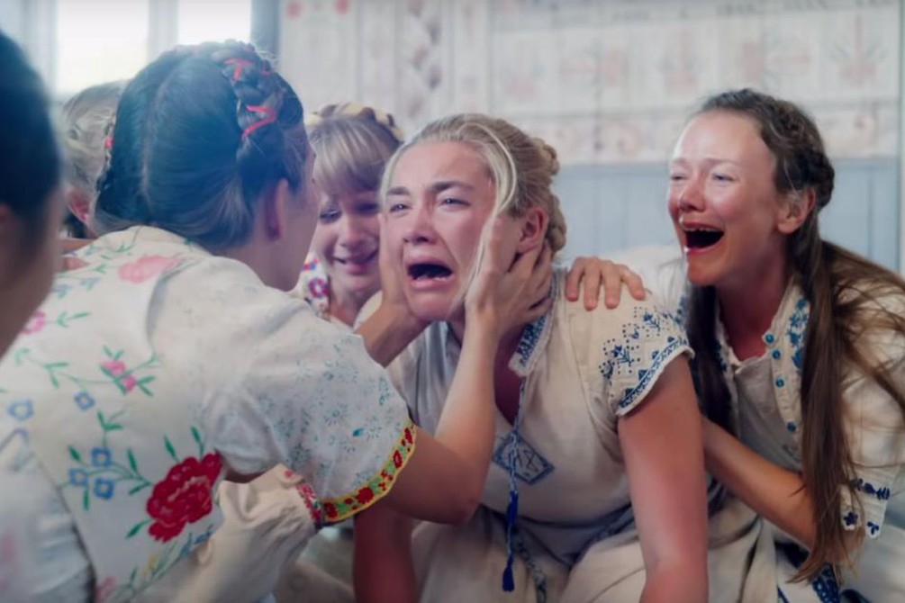 Florence Pugh and a group of women kneeling and screaming