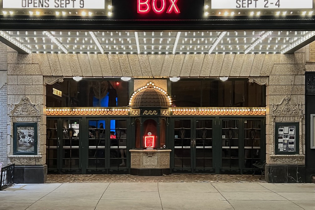 Entrance of the theatre centered on the original ticket booth with the new (2018) marquee and lights above.